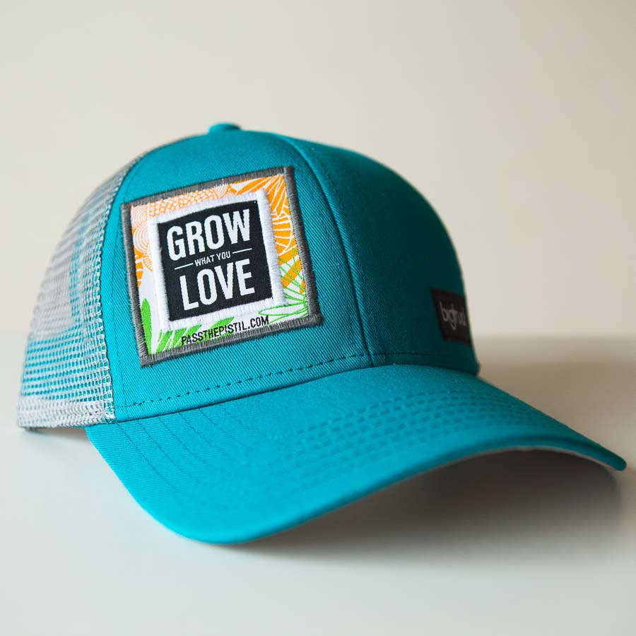 a Jade colored hat with "grow what you love" embroidered on the face